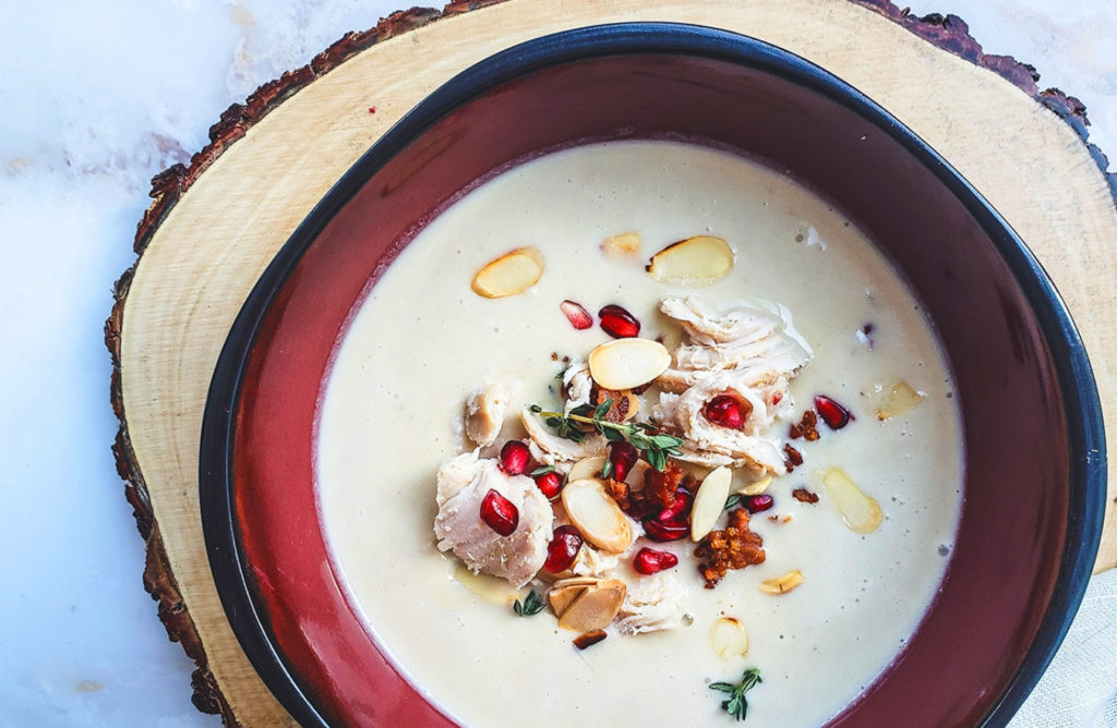 turkey cream soup with bacon, pine nuts, and pomegranate garnish